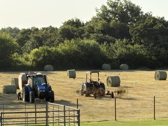 Rake and baler working the windrows at half-swath
