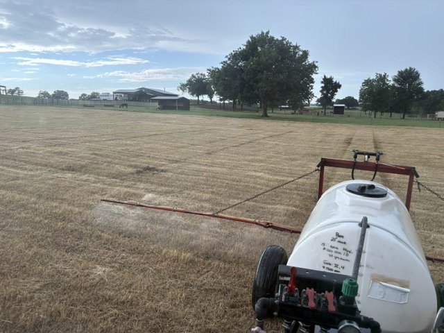 Sprayer boom feeding the field after the first cutting